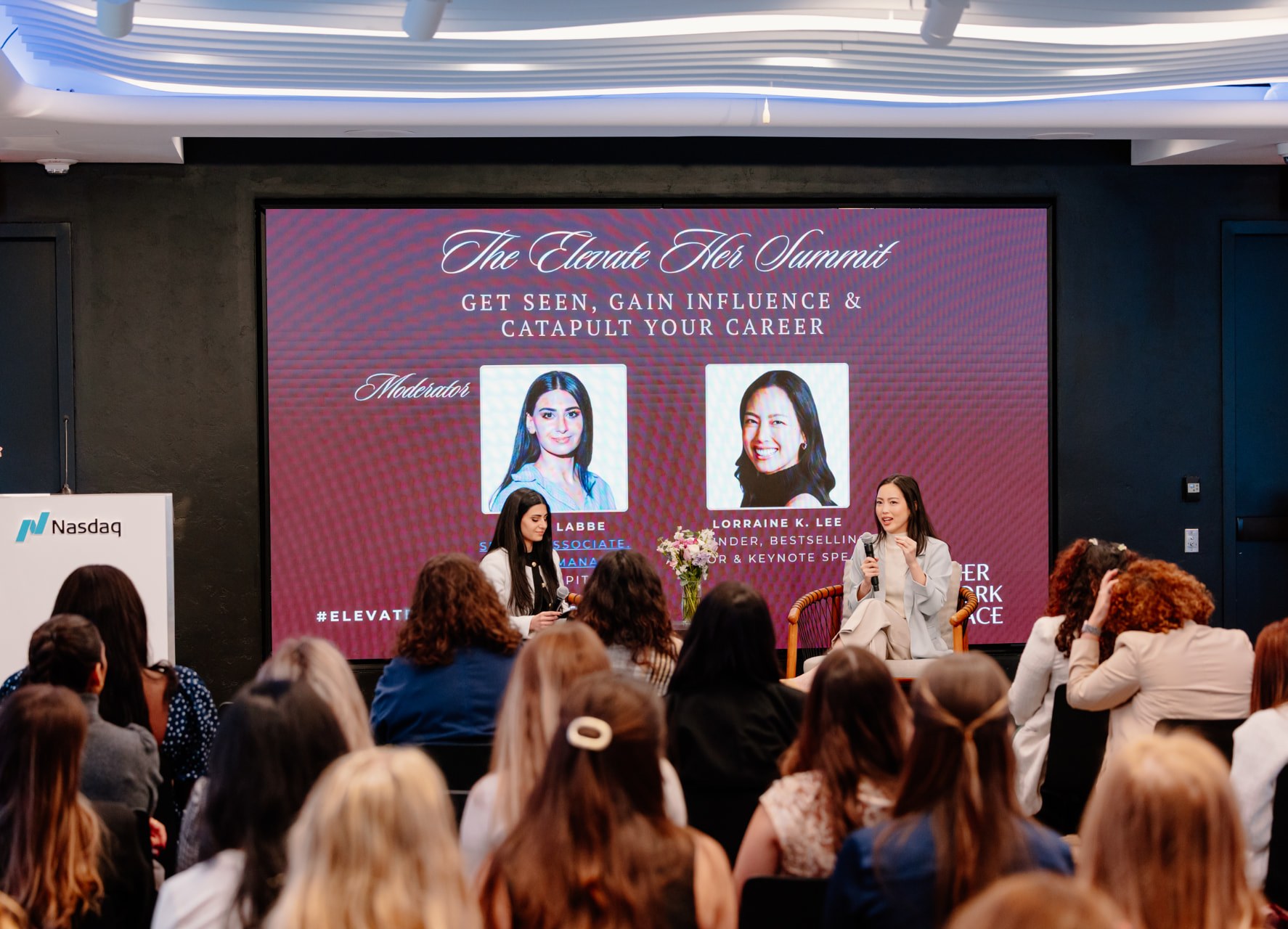 Lorraine K. Lee speaking on stage at last year's Elevate Her Summit at Nasdaq HQ